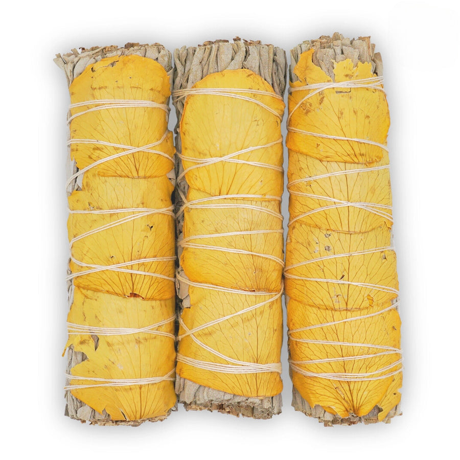 an organic white sage smudge stick with yellow rose petals that are wrapped into a bundle